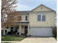 Charming two-story home featuring a light yellow exterior and a well-maintained front yard at 9873 Blue Ridge Way, Indianapolis, IN 46234