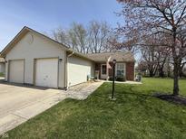 Charming single-story home with a well-maintained lawn, attached garage, and inviting entrance at 111 Woodberry Dr, Danville, IN 46122