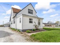 Quaint two-story home featuring charming details and a well-maintained lawn at 1126 N Anderson St, Elwood, IN 46036