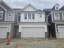 New two-story home with white siding and a two-car garage nestled in a vibrant community at 18745 Moray St, Westfield, IN 46074