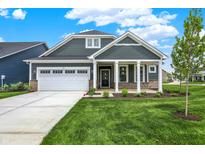Charming home with a two-car garage, stone accents, and manicured front yard at 19113 River Jordan Pass, Westfield, IN 46074