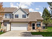 Charming townhome with a brick facade, well-maintained lawn, and a two-car garage at 253 Provincial Ln # Apt D, Avon, IN 46123