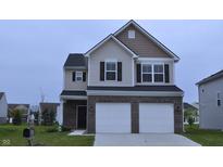 Charming two-story home featuring a brick-accented facade and a two-car garage at 3078 Creekridge Ct, Columbus, IN 47201