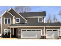 A craftsman style home with a two car garage, stone accents, and neutral toned horizontal and shake siding at 3818 Thomas Jefferson Ct, Westfield, IN 46074