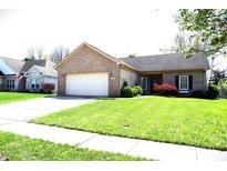 Charming single-story brick home with an attached two-car garage and a well-manicured front lawn at 45 Golden Tree Ln, Indianapolis, IN 46227