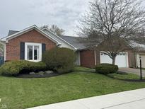Charming single Gathering home featuring a brick exterior and manicured front yard at 4586 Aldersgate Dr, Carmel, IN 46033
