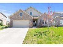 Charming brick home featuring an attached two-car garage and a well-manicured lawn on a sunny day at 5083 Castamere Dr, Noblesville, IN 46062