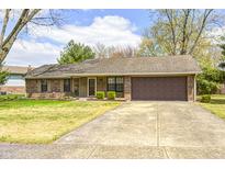 Charming single-story home featuring a well-manicured lawn and an attached two-car garage at 509 Nelson Dr, Brownsburg, IN 46112