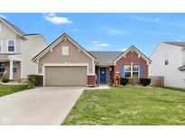 Charming home featuring brick and siding exterior, blue door and shutters, and a well-maintained front yard at 5157 Climbing Rose Pl, Indianapolis, IN 46254