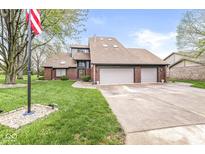 Beautiful two-story home featuring a brick exterior, attached three-car garage, and a green front yard at 5298 Royal Troon Way, Avon, IN 46123