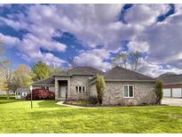 Attractive brick home with a well-manicured lawn and lovely landscaping at 5441 Red Hawk Ln, Greenwood, IN 46142
