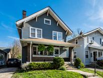Charming two-story home with blue siding and a brick-accented front porch at 5442 Hibben Ave, Indianapolis, IN 46219