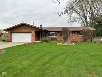 Charming brick ranch-style home with an attached garage and a well-manicured lawn at 5626 Hammon Dr, Brownsburg, IN 46112