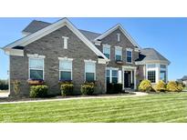 Charming two-story brick home with manicured lawn and well-maintained landscaping at 5802 Bentbrook Dr, Bargersville, IN 46106