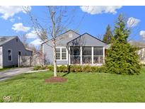 Charming gray home featuring a screened-in porch and a well-manicured lawn at 6164 Evanston Ave, Indianapolis, IN 46220