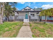 Charming home featuring a welcoming front porch, fresh paint, and a well-maintained front yard at 835 N Dearborn St, Indianapolis, IN 46201