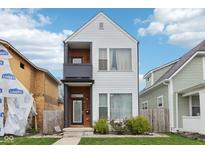 Modern two-story home featuring vinyl siding, balcony and charming front yard landscaping at 1015 Villa Ave, Indianapolis, IN 46203