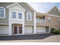 Inviting condo building with attached garages and well-maintained landscaping at 1575 Sierra Springs, Carmel, IN 46280