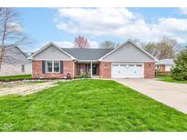 Charming brick home with a well-manicured lawn and an attached two-car garage at 1707 Lafayette Ave, Lebanon, IN 46052