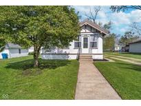 Charming home featuring a well-maintained lawn and a classic facade with a inviting front porch at 2735 S Taft Ave, Indianapolis, IN 46241