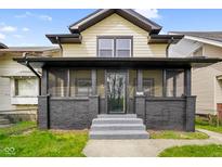 Inviting front entrance with gray stairs leading to a screened-in porch at 2926 Indianapolis Ave, Indianapolis, IN 46208