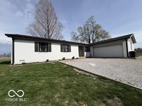 Charming single-story home with a white brick exterior and gravel driveway at 3689 S County Road 800 W, Coatesville, IN 46121