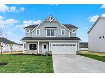 Charming two-story home with a two-car garage and a well-manicured lawn at 3787 Thomas Jefferson St, Westfield, IN 46074