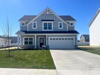 Charming two-story home with a well-manicured lawn and a spacious driveway, perfect for suburban living at 3787 Thomas Jefferson St, Westfield, IN 46074