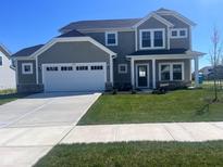 Charming two-story home featuring a two-car garage, landscaped yard, and inviting front porch at 4087 Railhead Ave, Westfield, IN 46074
