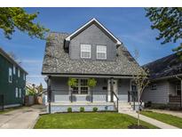 Charming renovated house with a gray exterior, inviting porch, and well-manicured lawn at 564 N Beville Ave, Indianapolis, IN 46201