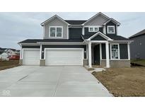 Two-story home with dark siding, white trim, large garage and concrete driveway at 5804 Summertree Pl, Whitestown, IN 46052