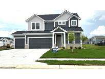 Two-story home with a two-car garage, gray siding, stone accents and a well-manicured front lawn at 5804 Summertree Pl, Whitestown, IN 46052