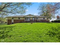 Well maintained single Gathering home with brick accents and a lush green lawn at 7482 N Maple Dr, Frankton, IN 46044