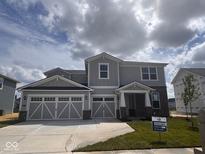 Beautiful two-story home with a two car garage, neutral siding, and brick accents at 827 Allandale Ave, Westfield, IN 46074