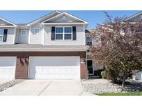 Two-story home with neutral siding, brick accents, and an attached two-car garage at 9770 Blue Violet Dr, Noblesville, IN 46060