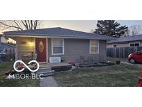 Cozy single-story home featuring a red front door, neutral siding, and a well-maintained front yard at 1006 Columbia Ave, Alexandria, IN 46001