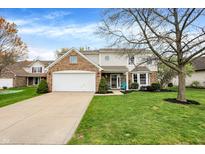 Charming two-story home featuring a brick facade, well-manicured lawn, and attached two-car garage at 10485 Alderwood Ct, Fishers, IN 46038