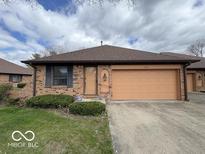 Charming single-story brick home with a two-car garage and well-maintained landscaping at 1215 Willow Springs Blvd, Brownsburg, IN 46112