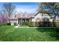 Charming home featuring a manicured lawn, covered porch, dormer windows, and red shutters at 1770 Valleywood Dr, Avon, IN 46123