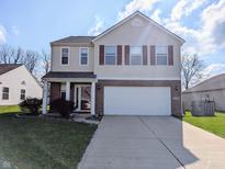 Charming two-story home with a two car garage, manicured lawn and classic architectural details at 18904 Planer Dr, Noblesville, IN 46062