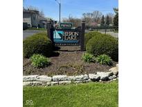 A welcoming Heron Lake condominium sign with lush landscaping at 3010 Lake Shore Dr # D, Indianapolis, IN 46205