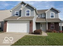 Charming two-story home featuring a spacious garage, neutral siding and brick accents at 3097 Limber Pine Dr, Whiteland, IN 46184