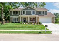 Charming two-story home with a well-manicured lawn and a classic combination of siding and stone accents at 3316 Eden Way Cir, Carmel, IN 46033