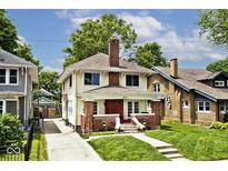 Charming two-story home with brick accents, a well-maintained lawn, and an inviting front porch at 3544 Guilford Ave, Indianapolis, IN 46205