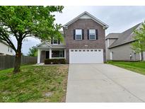 Two-story brick home with a large front yard and an attached two-car garage at 3930 Towhees Dr, Indianapolis, IN 46237