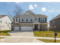 Beautiful two-story home with a three car garage, well maintained lawn, and stone accents at 4333 Ironclad Dr, Bargersville, IN 46106