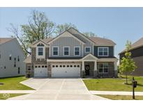 Charming two-story home with a three-car garage, stone accents, and well-manicured front lawn at 4333 Ironclad Dr, Bargersville, IN 46106