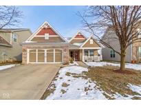 Charming home featuring a two-car garage, brick accents, and a quaint front porch at 6586 W Winding Bnd, McCordsville, IN 46055