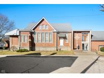 Brick building with gray roof, cross, and statue, set on a sunny street at 840 Cottage Ave, Indianapolis, IN 46203