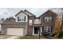 Charming two-story home with a brick and siding exterior and attached two-car garage at 8859 Delaney Dr, Fishers, IN 46038